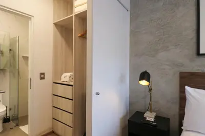 a bedroom with a bed and a lamp on a table at The Modern by Wynwood House in Lima