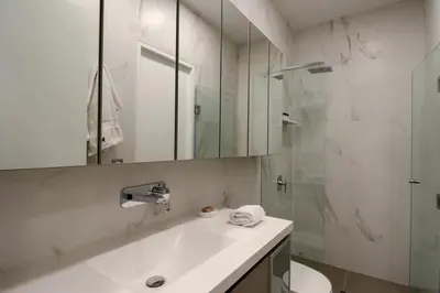 a white bathroom with a sink and a shower at The Modern by Wynwood House in Lima