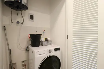 a washing machine in a room with a window at The Modern by Wynwood House in Lima