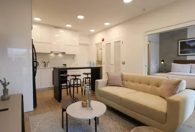 a living room with a couch and a kitchen at The Modern by Wynwood House in Lima