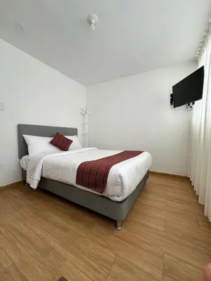 a bedroom with a bed and a flat screen tv at Hotel Sol de Canta in Canta