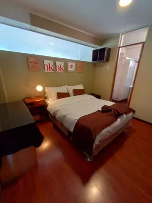 a bedroom with a large bed in a room at CasaHotel El Tambo Huancayo in Huancayo