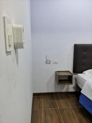 a small room with a bed and a small table at Hotel Grand Paradise Marcona in San Juan de Marcona