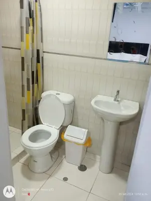 a bathroom with a toilet and a sink at Hotel Grand Paradise Marcona in San Juan de Marcona