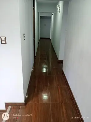 an empty hallway with wood floors and white walls at Hotel Grand Paradise Marcona in San Juan de Marcona