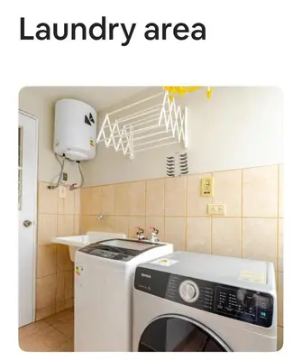 a laundry area with a washing machine in a kitchen at Miraflores Moonlight in Lima