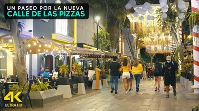 a group of people walking down a street at V Habitación Miraflores City in Lima