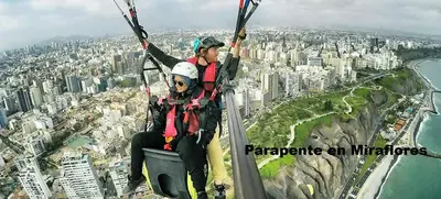 two people riding on a zip line over a city at V Habitación Miraflores City in Lima