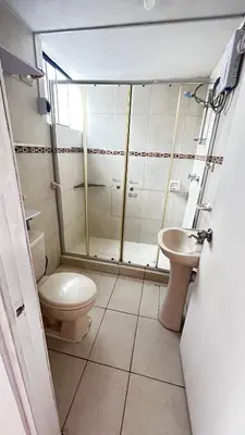 a bathroom with a shower and a toilet and a sink at V Habitación Miraflores City in Lima
