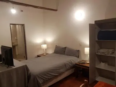 a bedroom with a bed and a television in it at Nico Homes in Cusco