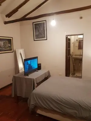 a bedroom with a bed and a tv on a table at Nico Homes in Cusco