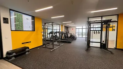 a gym with several treadmills and machines in a room at Apartament Social Tree 907 in Lima