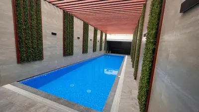 a large swimming pool in a building with plants at Apartament Social Tree 907 in Lima