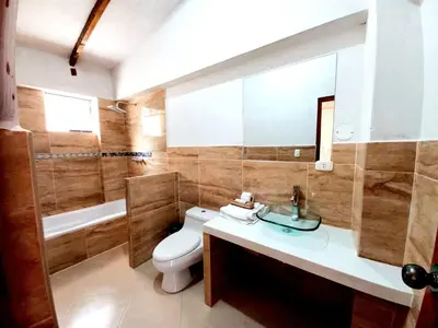 a bathroom with a toilet and a sink and a mirror at Hotel Humantay lodge Ollantaytambo in Ollantaytambo