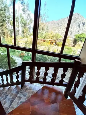 a view from a room with a large window at Hotel Humantay lodge Ollantaytambo in Ollantaytambo