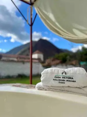a stack of towels sitting on a ledge with a view at Casa Machupicchu - Huayllabamba, Urubamba Cusco, Perú in Huayllabamba