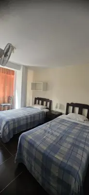 a hotel room with two beds and a window at Ollanta Rooftop Adults only in Ica