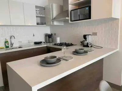 a kitchen with two plates and wine glasses on a counter at SWEET HOME MIRAFLORES in Lima