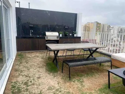 a table and two chairs on a balcony with a kitchen at SWEET HOME MIRAFLORES in Lima