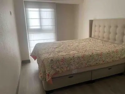 a bedroom with a large bed with a bed frame at SWEET HOME MIRAFLORES in Lima