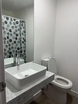 a white bathroom with a sink and a toilet at SWEET HOME MIRAFLORES in Lima
