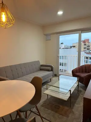 a living room with a couch and a table at SWEET HOME MIRAFLORES in Lima