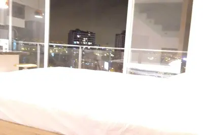 a window with a view of a city at night at Barranco landscape suite boardwalk in Lima