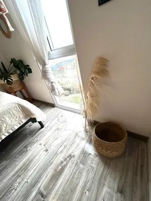 a bedroom with a window and a basket on the floor at departamento encantador céntrico con balcon in Lima