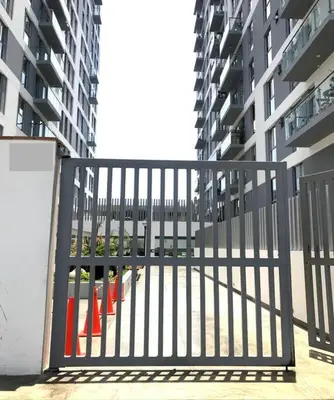 a gate with orange cones in front of a building at departamento encantador céntrico con balcon in Lima