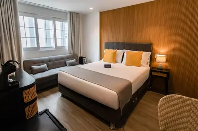 a hotel room with a large bed and a couch at Blu Hotel Boutique in Lima