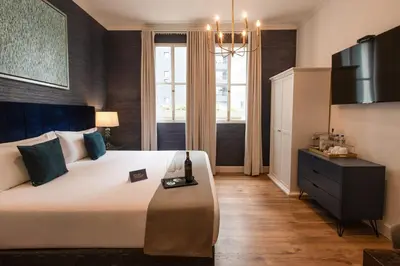 a bedroom with a large bed and a television at Blu Hotel Boutique in Lima