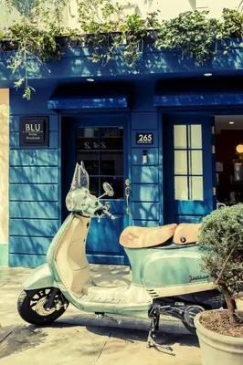 a scooter parked in front of a blue building at Blu Hotel Boutique in Lima