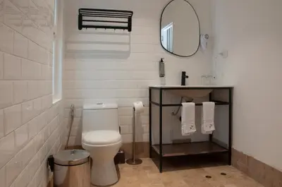 a bathroom with a toilet and a sink and a mirror at Blu Hotel Boutique in Lima