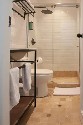 a bathroom with a toilet and a glass shower at Blu Hotel Boutique in Lima