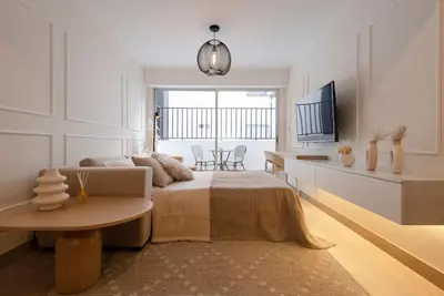 a bedroom with a bed and a table and a tv at Stunning Modern 1BD Apartment in Barranco in Lima