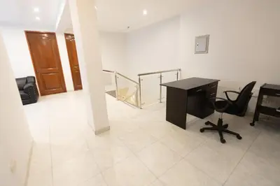 an office with a desk and chairs in a room at Casa completa, 5 dormitorios y jardín in Ayacucho