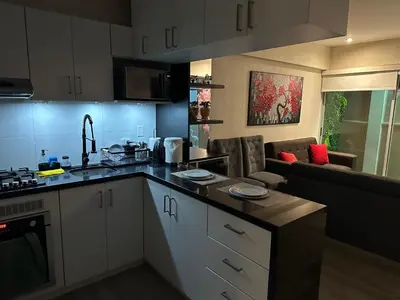 a kitchen with a counter top and a living room at Big Apartment 2 rooms next to Miraflores in Lima