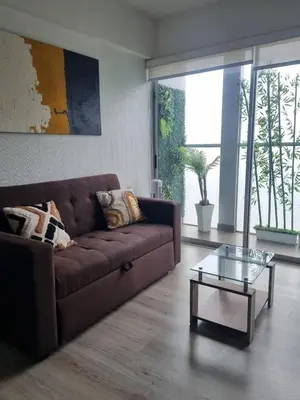 a living room with a brown couch and a glass table at Big Apartment 2 rooms next to Miraflores in Lima