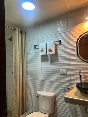 a bathroom with a toilet and a sink at TAYWA HOTEL in Machu Picchu