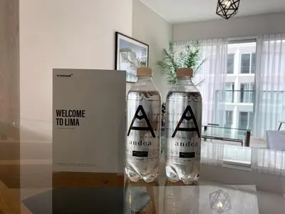 two bottles of water sitting on a glass table at Sky Balta in Miraflores by Wynwood House in Lima