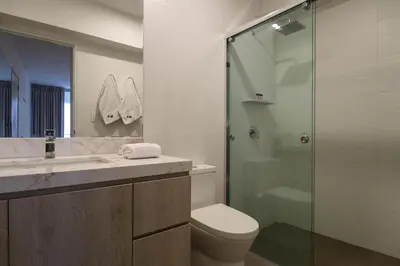 a bathroom with a toilet and a glass shower at Sky Balta in Miraflores by Wynwood House in Lima