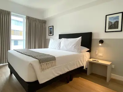 a bedroom with a large bed and a window at Sky Balta in Miraflores by Wynwood House in Lima
