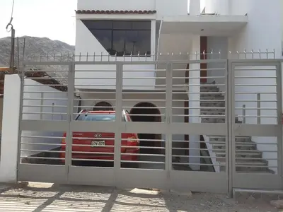 a gate with a car parked inside of a building at El Valle - Lunahuaná in Lunahuaná