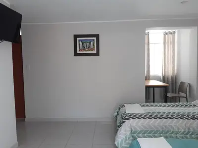 a hotel room with two beds and a window at El Valle - Lunahuaná in Lunahuaná