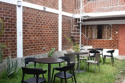 a group of tables and chairs in the grass at El Valle - Lunahuaná in Lunahuaná