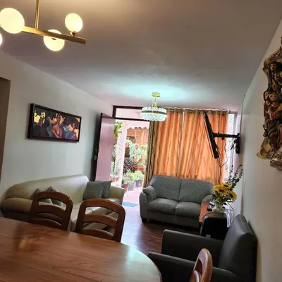 a living room with a table and chairs at Casita Cultura in Lima