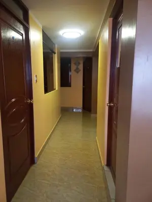 a hallway with yellow walls and doors and a tile floor at Gia's apartments in Cusco