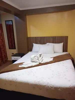 a bedroom with a bed with towels on it at Gia's apartments in Cusco