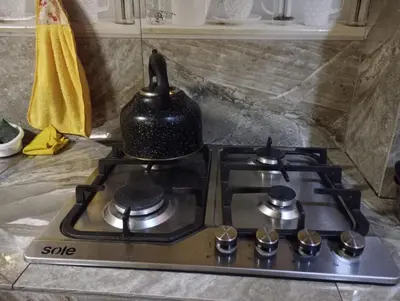 a stove top with a tea kettle on top of it at Gia's apartments in Cusco