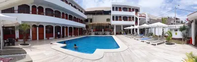 a person swimming in a swimming pool in a building at Hotel Curasi in Ica